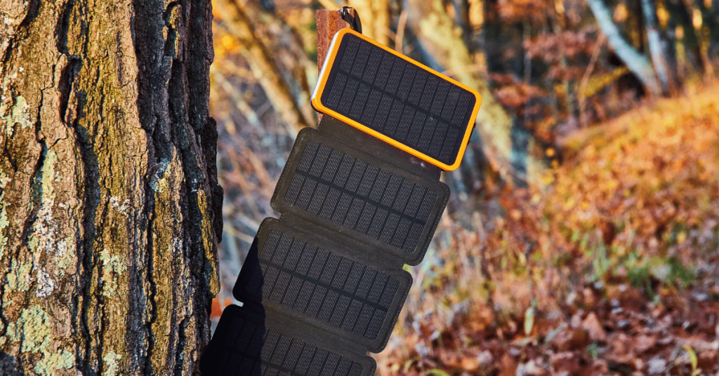 Solar panel charger hand on a stand outdoors in the woods